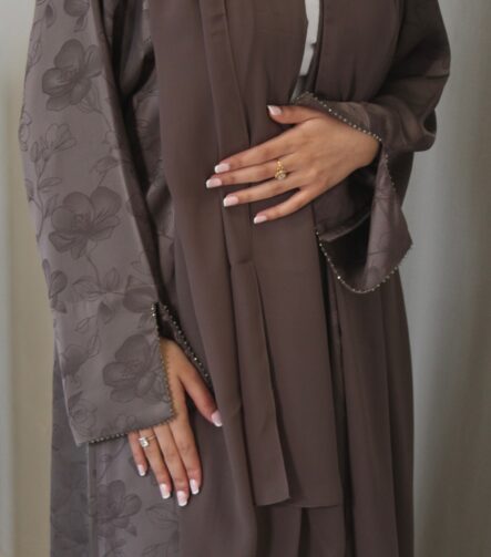 Fabric - Jacquard Luxurious mocha jacquard abaya with delicate floral detailing, elegant beaded sleeves and neckline, finished with a soft matching chiffon scarf