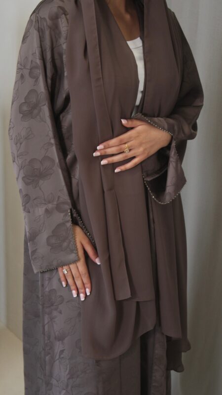 Fabric - Jacquard Luxurious mocha jacquard abaya with delicate floral detailing, elegant beaded sleeves and neckline, finished with a soft matching chiffon scarf