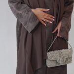 Serene abaya Fabric - Jacquard Luxurious mocha jacquard abaya with delicate floral detailing, elegant beaded sleeves and neckline, finished with a soft matching chiffon scarf