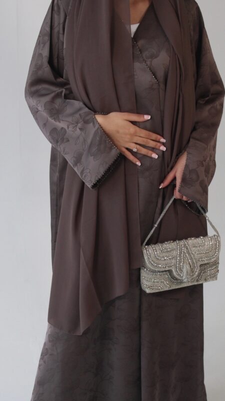 Serene abaya Fabric - Jacquard Luxurious mocha jacquard abaya with delicate floral detailing, elegant beaded sleeves and neckline, finished with a soft matching chiffon scarf