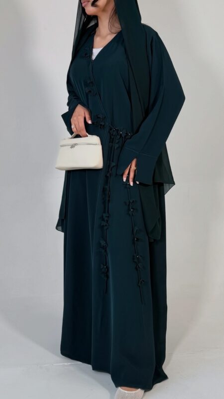 Elegant deep teal abaya featuring delicate 3D floral detailing with pearl-beaded flower centres, inner and outer tie closures Comes with a premium chiffon scarf Fabric - Korean nida Colours - Teal | Berry