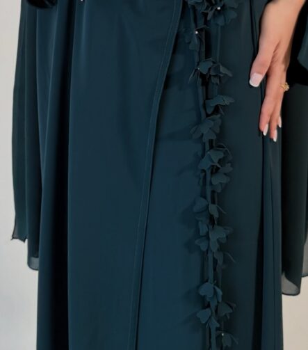 Elegant deep teal abaya featuring delicate 3D floral detailing with pearl-beaded flower centres, inner and outer tie closures Comes with a premium chiffon scarf Fabric - Korean nida Colours - Teal | Berry By pardah