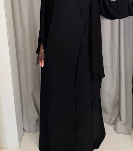 Wrap abaya - Black Fabric - Korean nida 2 Piece - abaya & scarf Soft, flowing fabric, featuring delicate lace sleeves, an inner tie for a secure fit, and an outer tie for an adjustable, flattering silhouette. Perfect for a timeless and modest look. By pardah