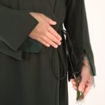 Net sleeve wrap abaya secured with 3 hidden snap buttons inside, wrapped in adjustable beaded strings for a finished look.