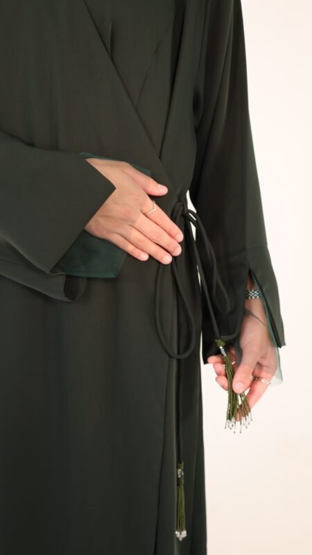 Net sleeve wrap abaya secured with 3 hidden snap buttons inside, wrapped in adjustable beaded strings for a finished look.